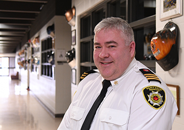 Brian Brown in the hallway of helmets at the Emergency Training Centre.