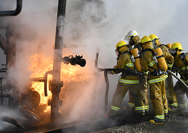 Students Ashlea Suderman and Eric Bogart go beyond the classroom as they join their classmates for hands-on industrial firefighting.