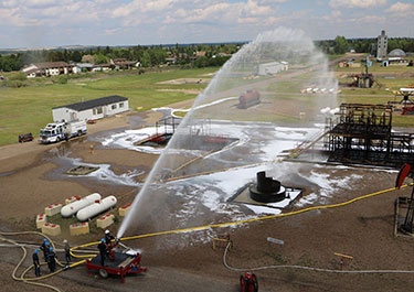 Suncor Energy Emergency Services Department trains with a specialized firefighting nozzle to respond industrial fire scenarios.