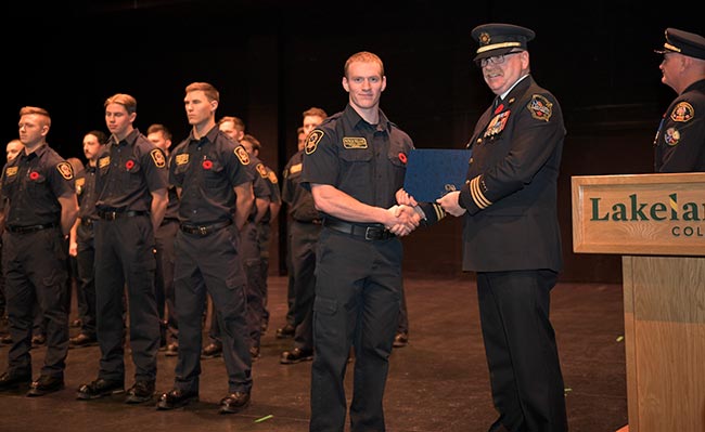 EST receiving certificate at recognition ceremony