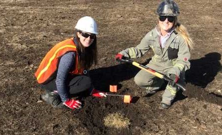 students plant grass in fescue restoration
