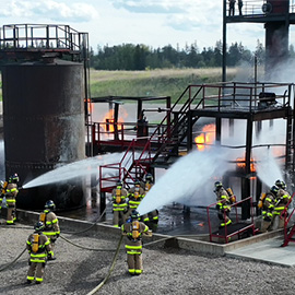 Student firefighters working on an industrial complex training