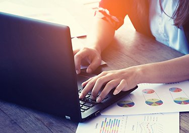 A person typing on a laptop