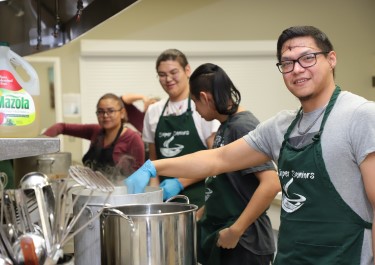 Levin Smith cooking in collective kitchen