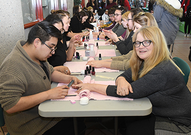 Esthetician students offer manicures.