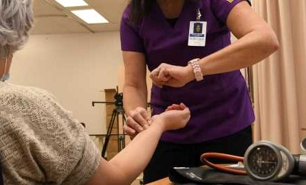 health care aide takes pulse