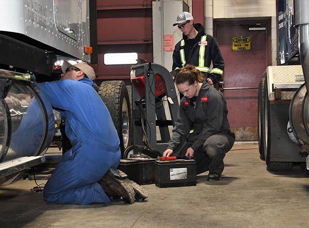 Students working on heavy equipment