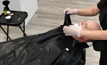 student giving hot towel shave
