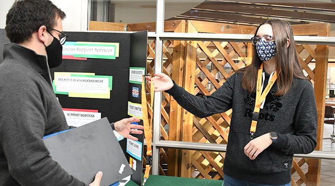 Peer coach Kara Mouly helps out at the information booth on National Day for Truth and Reconciliation.