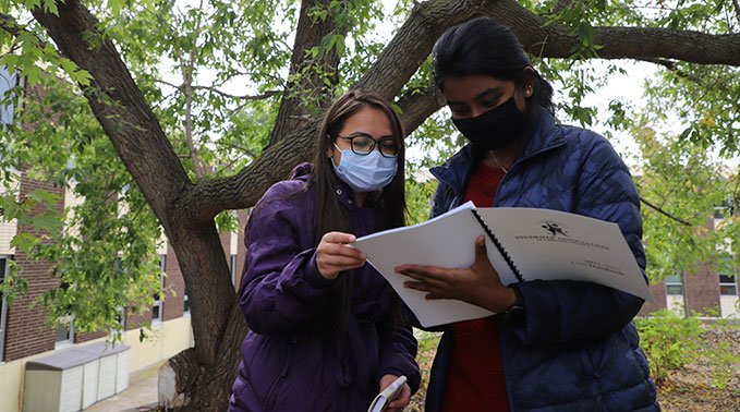 two students checking playscape plan