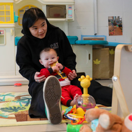 Student working with children in the classroom