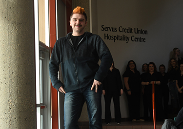 A model feels good about his new look as he walks down the runway.
