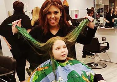 Lakeland student Kyla Millard cuts a client's hair