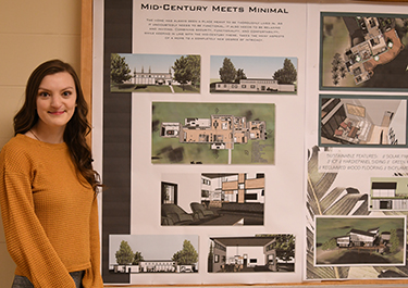 Katlynn Healey stands with her mid-century modern and sustainable design project.