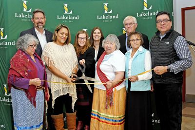 Alice Wainwright-Stewart, president and CEO of Lakeland College, cuts a piece of leather to officially open the Indigenous Student Lounge at the Lloydminster campus