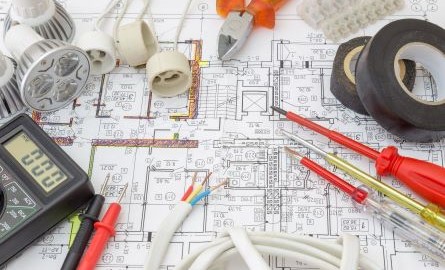 electrician's tools on a building's electrical plan