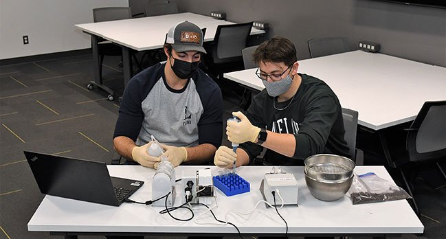 Bachelor of agriculture technology students, Colby Yaremie (left) and Matthew Pfeffer (right), prepare soil samples for analysis using the iMETOS MobiLab.