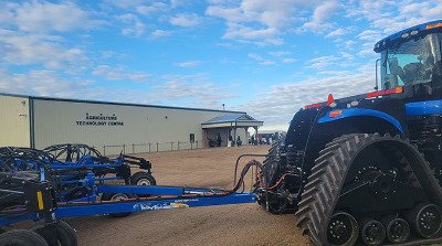 Exterior of the Agriculture Technology Centre behind New Holland equipment.