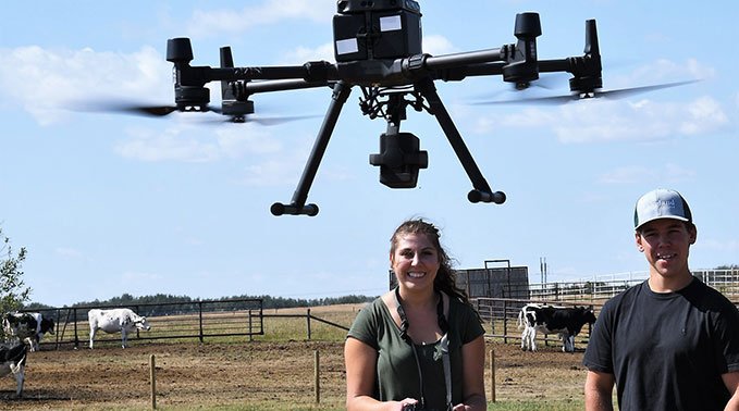 Two students operate a drone