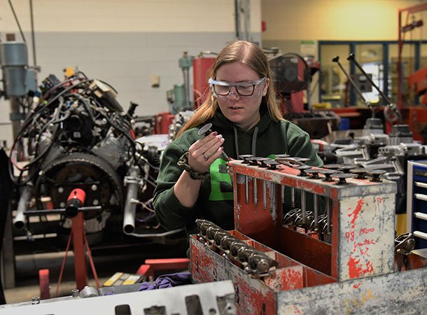 Student inspecting a part