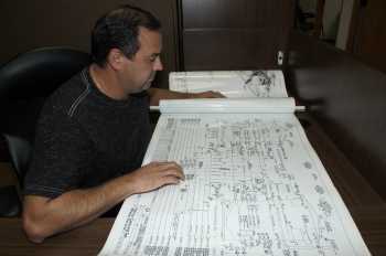 Man looking over a piping diagram