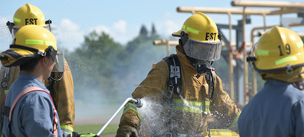 Student firefighter being washed off after hazardous materials training