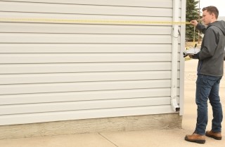 Student measuring a garage