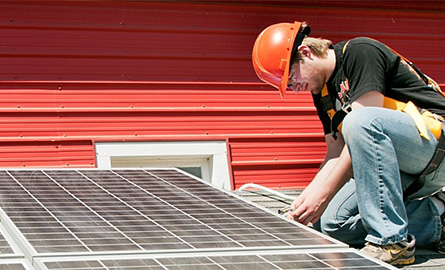 Student installing solar panels