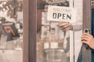 Open sign on a small business glass door