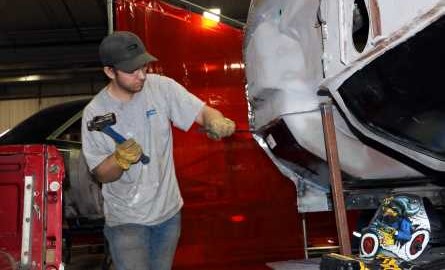 young man working on vehicle door