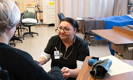 Student taking the blood pressure of a patient