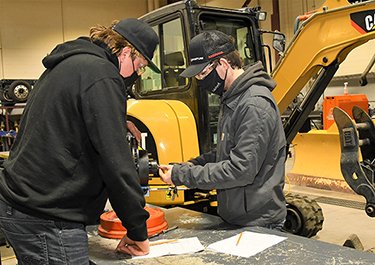 Heavy equipment technician apprentices during a lab.