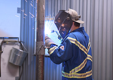 Grade 11 student Skylar Dary shows off his welding skills.