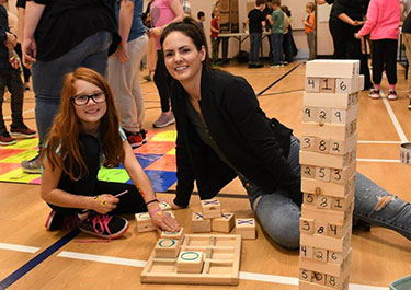 Linsey playing jenga at Math Fair