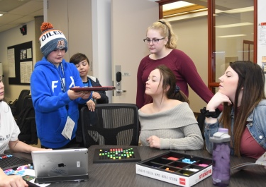 Grade 6 student Abdullah Nasir instructs Joshua Lang at the littleBits station