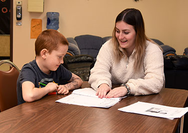 University transfer students tutor kids at St. Joseph Elementary School on Nov. 7.
