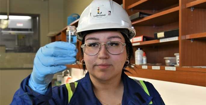 lab student testing water