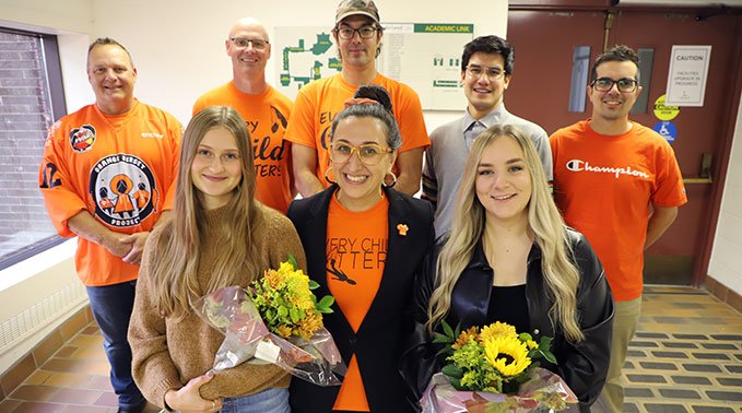 Hannah (front, left) and Tiarra (front, right) with Rochelle Horne (front, centre), interior design technology program head and other faculty members