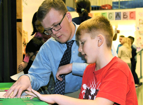 Teacher helping a student in a classroom