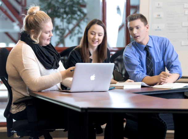 Lakeland business students looking at a laptop