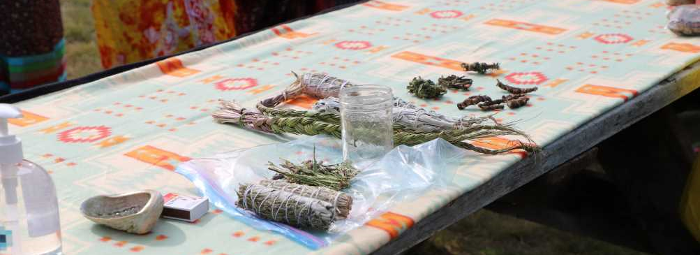 sage and sweet grass laid out before an Indigenous wellness walk