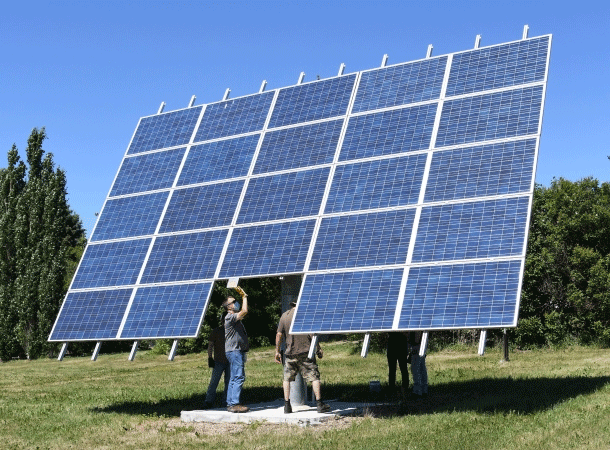 Student inspecting solar panels