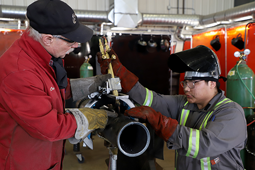 Lakeland trades instructor Owen Lakusta instructs an intro to welding student